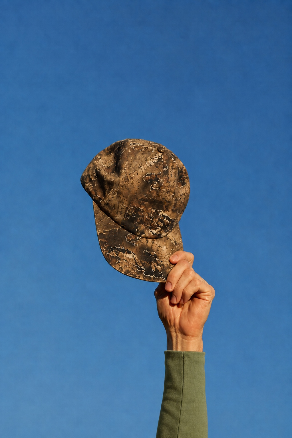 Field — camo cap raised to sky